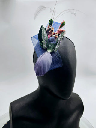 Lori- Small navy blue fascinator with green velvet leaves blue humming bird and featheres