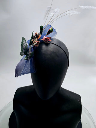 Lori- Small navy blue fascinator with green velvet leaves blue humming bird and featheres