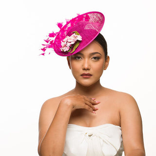 Pink fascinator with leather and feather trims