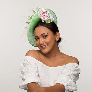 Xena- green fascinator finished with leather flower